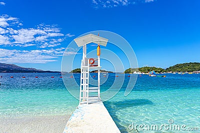 lookout pier in the crystal clear bathing area of â€‹â€‹Bora Bora beach in the town of Ksamil in Albania. Stock Photo